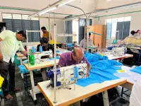 Factory worker stitching a corporate polo t-shirt on a Juki machine at the Anuvavi partner factory in Tiruppur