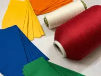 A photo a a few colourful yarns and fabrics