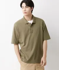 An Asian man wearing a trendy oversized polo t shirt in olive green colour