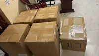Sealed cardboard boxes of corporate polo t-shirts marked ready for dispatch at Anuvavi Apparels