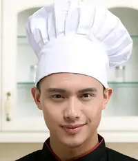 A chef wearing a white colour chef hat