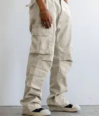 A photo showing a man wearing a pair of trendy cargo pants in light grey colour