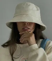 A woman wearing a white coloured bucket hat