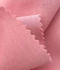 A close up image of a light red colour zen interlock knit fabric roll