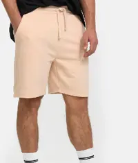 A man wearing a pair of comfortable shorts in cream colour