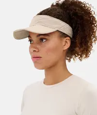 A lady wearing a tennis style visor cap